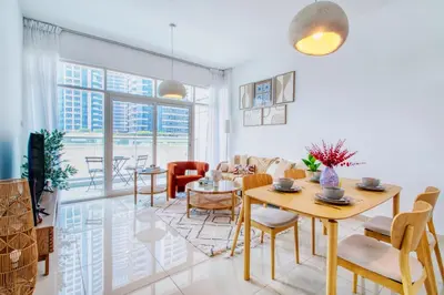 a living room with a table and chairs at ShoresInn - Outdoor Retreat with Private Terrace in Dubai