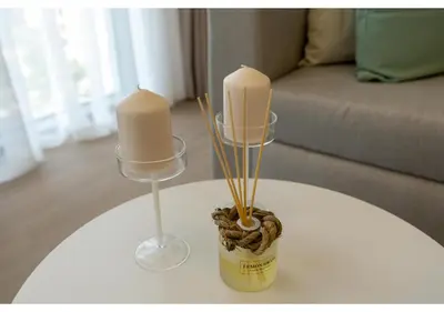 a table with two candles and a wine glass at Bright and Modern 1BR Midtown Near Expo Site by Vibel in Dubai