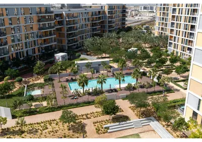 an aerial view of a pool with palm trees and buildings at Bright and Modern 1BR Midtown Near Expo Site by Vibel in Dubai