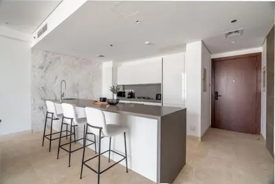 a kitchen with a bar with stools and a counter top at GuestReady - Modern retreat in Business Bay in Dubai