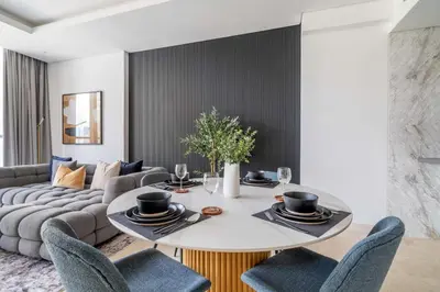 a dining room with a table and a couch at GuestReady - Modern retreat in Business Bay in Dubai
