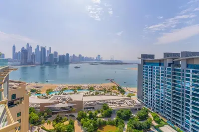 an aerial view of a city and a body of water at Palm Jumeirah Seven Palm 1 Bedroom with infinity pool and Palm jumeirah beach in Dubai