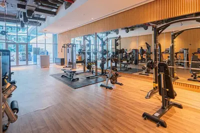 a gym with lots of treadmills and machines at Palm Jumeirah Seven Palm 1 Bedroom with infinity pool and Palm jumeirah beach in Dubai