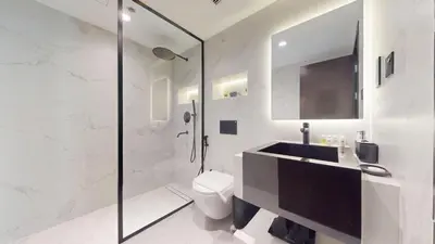 a white bathroom with a sink and a toilet at Marina Quays - Calm One Bedroom in Dubai