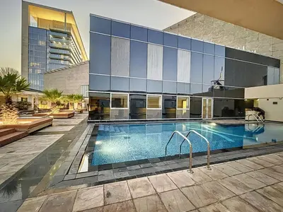 a swimming pool in front of a building at Sky Gardens - Cosy Studio in DIFC in Dubai