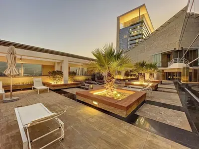 a building with a courtyard with chairs and a fountain at Sky Gardens - Cosy Studio in DIFC in Dubai