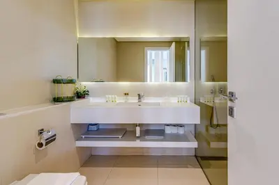 a bathroom with a white sink and a mirror at Sleek and Modern 2BR in West Avenue, Dubai Marina- Allsopp&Allsopp in Dubai