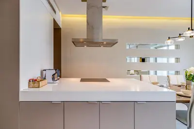 a kitchen with a white counter and a sink at Sleek and Modern 2BR in West Avenue, Dubai Marina- Allsopp&Allsopp in Dubai