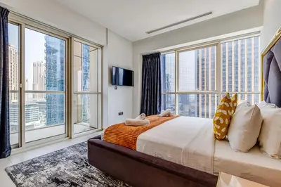 a bedroom with a large bed and large windows at Sleek and Modern 2BR in West Avenue, Dubai Marina- Allsopp&Allsopp in Dubai