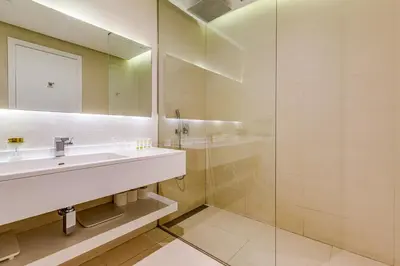 a bathroom with a sink and a shower at Sleek and Modern 2BR in West Avenue, Dubai Marina- Allsopp&Allsopp in Dubai