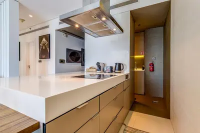 a kitchen with a white counter top and a sink at Sleek and Modern 2BR in West Avenue, Dubai Marina- Allsopp&Allsopp in Dubai