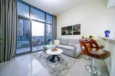 a living room with a couch and a table at Chic 1BR Getaway- 4min Walk to Business Bay Metro & 10min to Burj Khalifa in Dubai