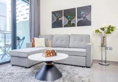 a living room with a couch and a table at Chic 1BR Getaway- 4min Walk to Business Bay Metro & 10min to Burj Khalifa in Dubai