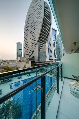 a view from the roof of a building with a swimming pool at Chic 1BR Getaway- 4min Walk to Business Bay Metro & 10min to Burj Khalifa in Dubai