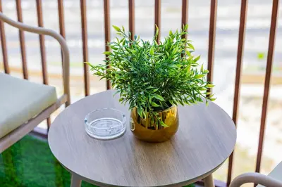 a small table with a potted plant on it at Luxury Apt in Dubai Hills Burj Khalifa views in Dubai
