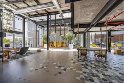 a large room with tables and chairs and windows at Luxury Apt in Dubai Hills Burj Khalifa views in Dubai