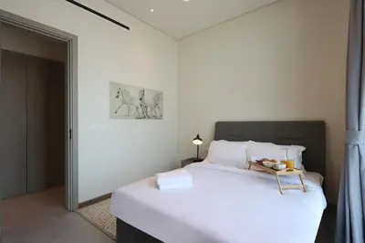 a bedroom with a large white bed in a room at Livbnb - Stay at Signature Livings Penthouse, JVC in Dubai