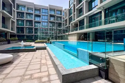 a swimming pool in the middle of a building at Livbnb - Stay at Signature Livings Penthouse, JVC in Dubai