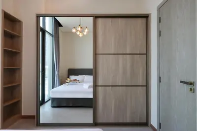 a bedroom with a large mirror and a bed at Livbnb - Stay at Signature Livings Penthouse, JVC in Dubai