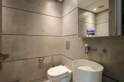a bathroom with a toilet and a sink at Livbnb - Stay at Signature Livings Penthouse, JVC in Dubai