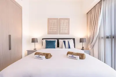 a bedroom with a white bed with two pillows on it at Premium Home Minutes away from Burj Khalifa in Dubai