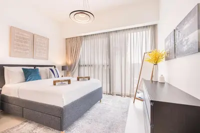 a bedroom with a large bed and a desk at Premium Home Minutes away from Burj Khalifa in Dubai