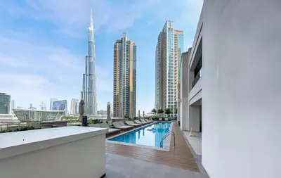 a view of the city from the rooftop pool of a building at Premium Home Minutes away from Burj Khalifa in Dubai