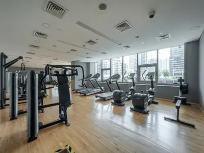 a gym with treadmills and cardio equipment in a building at Walk to JBR Beach I Marina Studio Stay I Wi-fi in Dubai