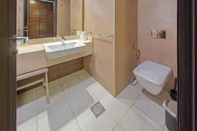 a bathroom with a sink and a toilet at Walk to JBR Beach I Marina Studio Stay I Wi-fi in Dubai