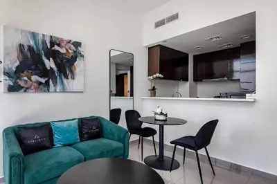 a living room with a couch and a table at Stylish 1BR Apartment at DAMAC Merano Tower with Great View in Dubai