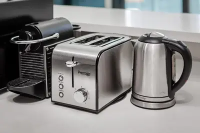 a toaster and a coffee maker on a counter at Stylish 1BR Apartment at DAMAC Merano Tower with Great View in Dubai