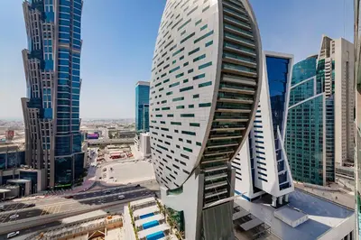 a view of a tall building in a city at Stylish 1BR Apartment at DAMAC Merano Tower with Great View in Dubai