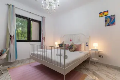 a bedroom with a bed and a chandelier at Yansoon 7,Oldtown-Downtown - 2BR & Maids Room - Allsopp&Allsopp in Dubai