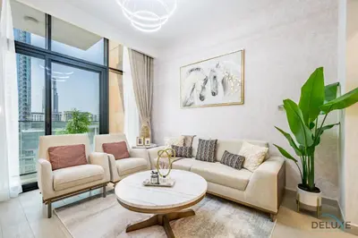 a living room with two couches and a table at Inviting 2BR Apartment in Azizi Riviera 39, Al Merkadh by Deluxe Holiday Homes in Dubai
