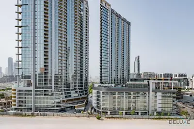 two tall buildings in a city with buildings at Inviting 2BR Apartment in Azizi Riviera 39, Al Merkadh by Deluxe Holiday Homes in Dubai