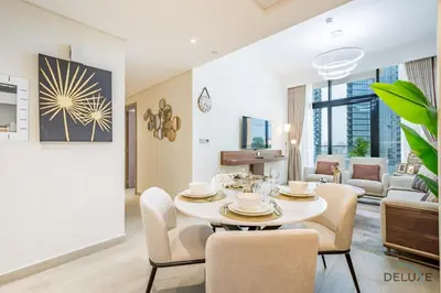 a living room with a white table and chairs at Inviting 2BR Apartment in Azizi Riviera 39, Al Merkadh by Deluxe Holiday Homes in Dubai