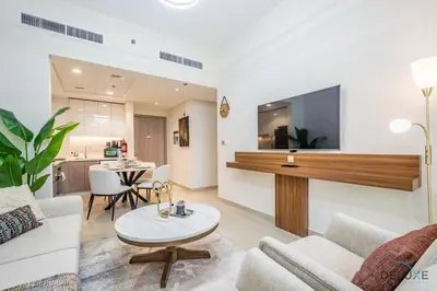 a living room with a couch and a table at Inviting 2BR Apartment in Azizi Riviera 39, Al Merkadh by Deluxe Holiday Homes in Dubai