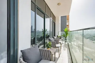 a row of chairs on the balcony of a building at Inviting 2BR Apartment in Azizi Riviera 39, Al Merkadh by Deluxe Holiday Homes in Dubai