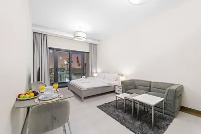 a living room with a couch and a bed at Chic Studio Near Burj Khalifa, Dubai Opera & Dubai Mall with City Skyline Views in Dubai