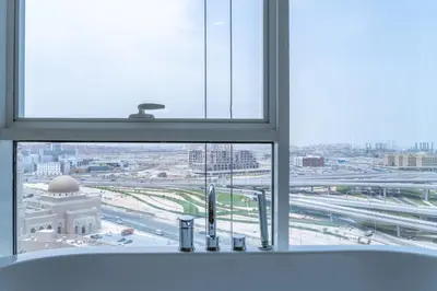 a bathroom window with a view of a city at Paradise of the Mind by Lagom in Dubai