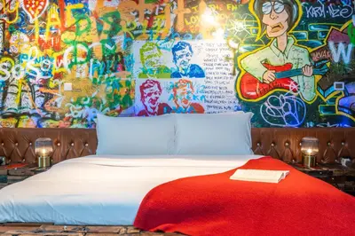 a bed in front of a wall covered in graffiti at Paradise of the Mind by Lagom in Dubai