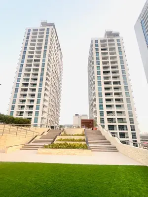 two tall buildings with a staircase in front of some grass at Luxury One Bedroom Apartment In Dubai Marina in Dubai