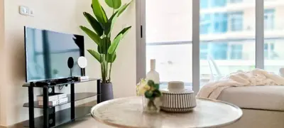 a living room with a coffee table and a tv at Luxury One Bedroom Apartment In Dubai Marina in Dubai