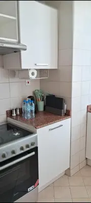 a kitchen with white cabinets and a stove at Luxury One Bedroom Apartment In Dubai Marina in Dubai