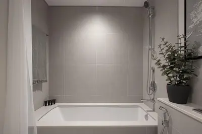 a white bath tub with a potted plant in a bathroom at Burj Crown - Urban Chic Opera Boulevard View, Walk to Dubai Mall in Dubai