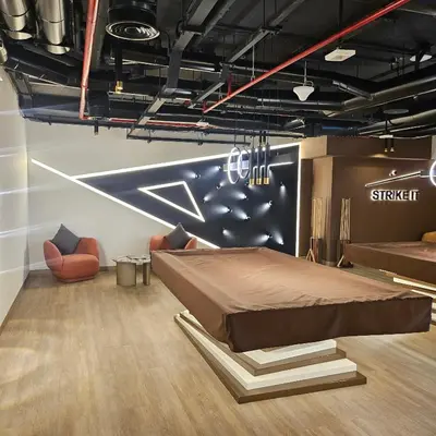 a bedroom with a bed and chairs in a room at Spacious Studio MeDoRe Tower in Dubai