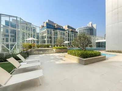 a patio with chairs and tables in front of a building at InstaWorthy Aesthetic 1BR APT, 5mins to Dubai Mall in Dubai