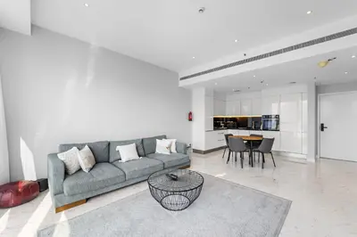 a living room with a couch and a table at InstaWorthy Aesthetic 1BR APT, 5mins to Dubai Mall in Dubai