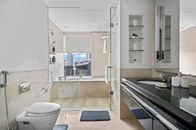 a bathroom with a toilet and a sink and a shower at Amazing 1 Bd Marina View LLC in Dubai