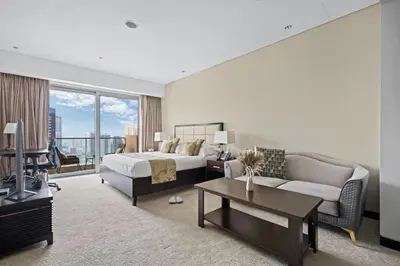 a large hotel room with a bed and a couch at Amazing 1 Bd Marina View LLC in Dubai